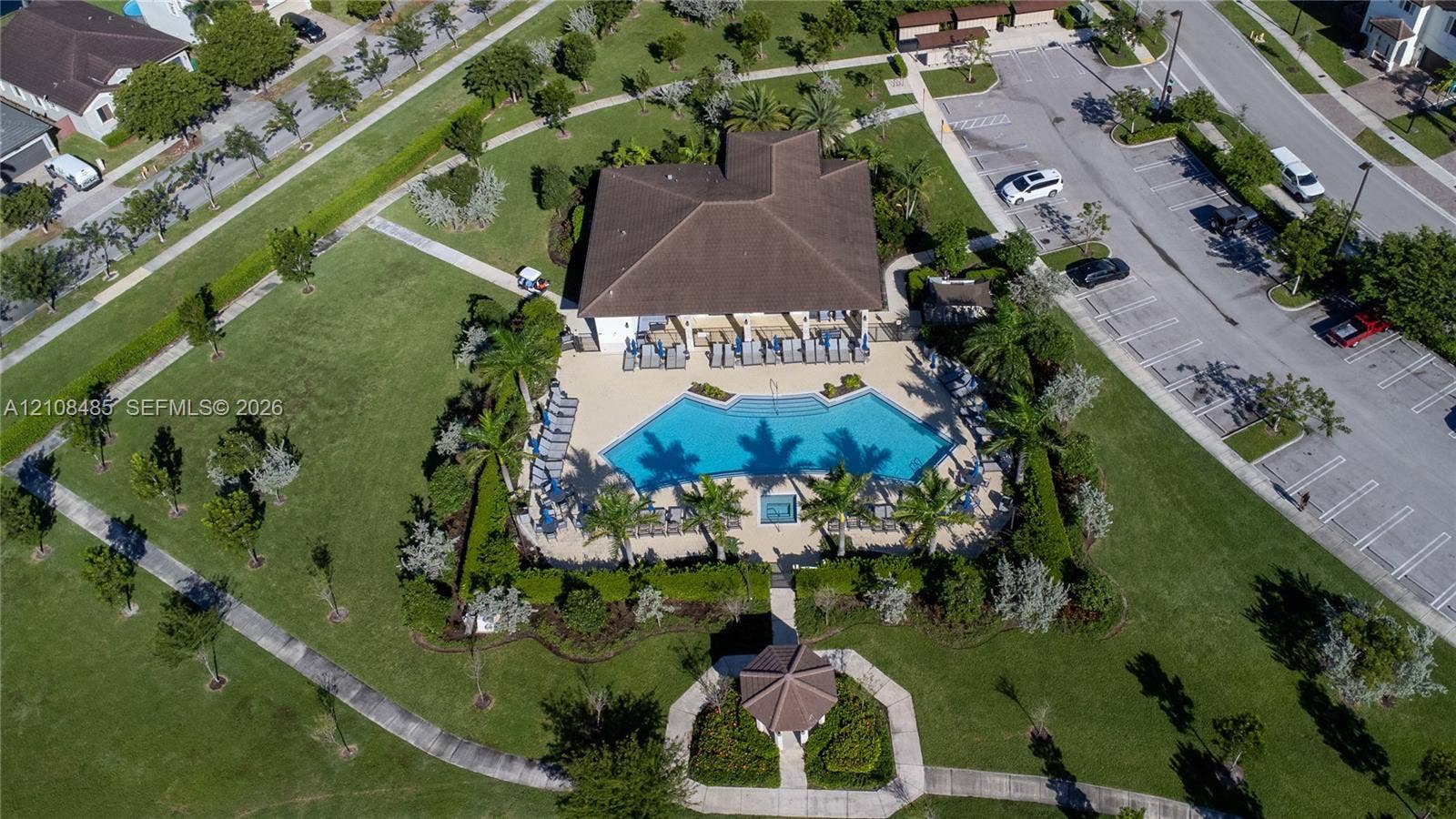 10217 SW 231st Lane, Miami, FL 33190 Community recreation center featuring an outdoor swimming pool, spa, surrounding paved deck, covered gazebo, and landscaped grounds