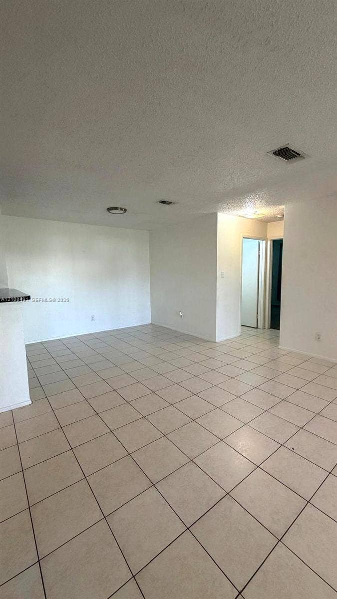 11233 W Atlantic Boulevard, #103, Coral Springs, Coral Springs, FL 33071 Open floor plan featuring light-colored tile flooring, neutral wall tones, and recessed lighting fixtures