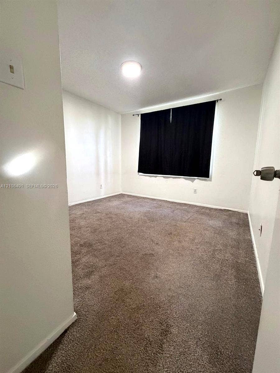 11233 W Atlantic Boulevard, #103, Coral Springs, Coral Springs, FL 33071 Neutral interior featuring wall-to-wall carpeting and a ceiling-mounted light fixture