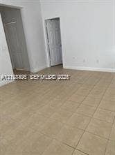 11835 SW 27th Street, #801, Miramar, Miramar, FL 33025 Interior space featuring neutral wall paint, large-format ceramic tile flooring, and multi-panel interior doors