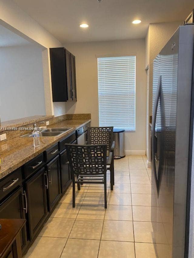 11835 SW 27th Street, #801, Miramar, Miramar, FL 33025 Kitchen featuring dark-finish cabinetry, stone countertops, double-basin stainless steel sink, recessed lighting, and tile flooring