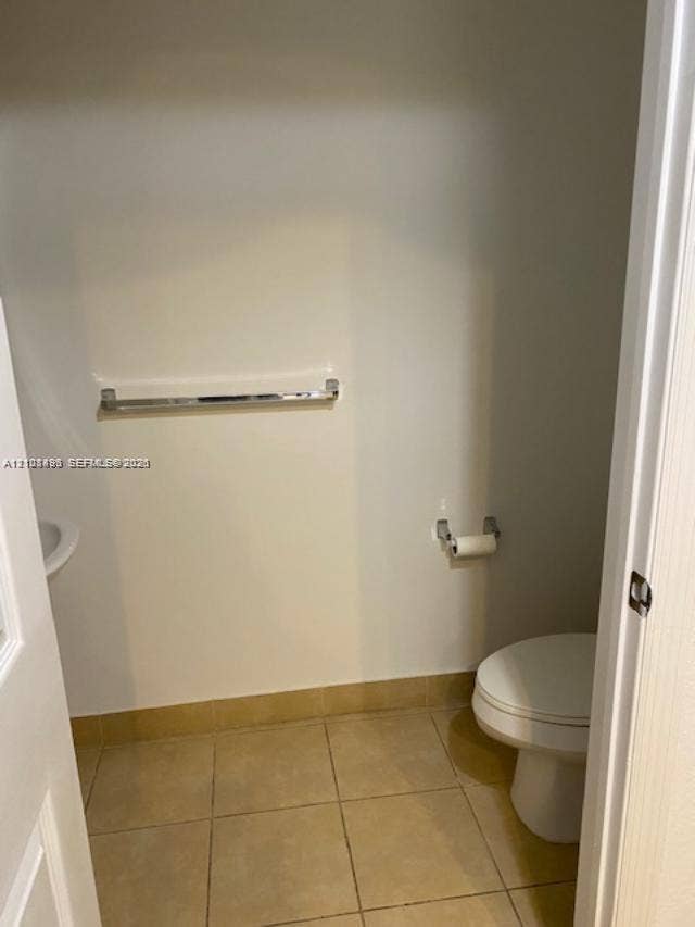 11835 SW 27th Street, #801, Miramar, Miramar, FL 33025 Restroom featuring large-format tile flooring, a wall-mounted towel bar, and a dedicated tissue holder