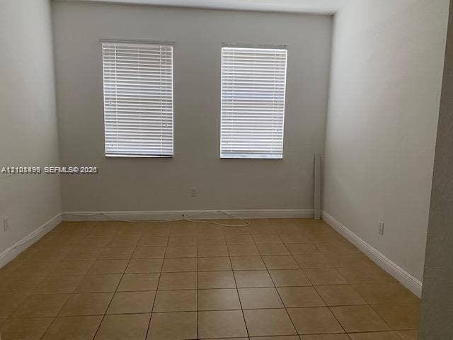 11835 SW 27th Street, #801, Miramar, Miramar, FL 33025 Interior space featuring ceramic tile flooring, neutral wall tones, and two windows equipped with horizontal blinds