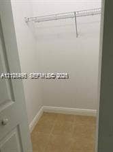 11835 SW 27th Street, #801, Miramar, Miramar, FL 33025 Reach-in closet featuring white walls, neutral floor tile, and built-in wire shelving