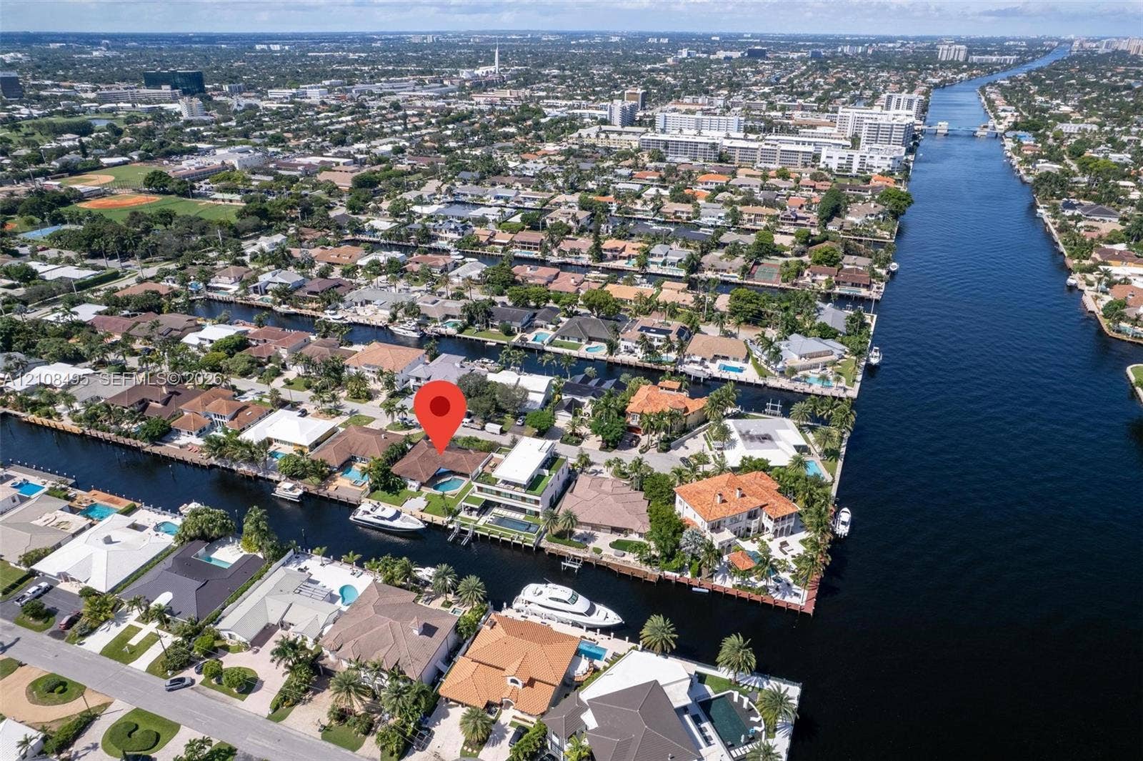 3080 NE 43rd Street, Fort Lauderdale, FL 33308 Aerial perspective of waterfront property featuring a private swimming pool, deep-water dockage, and direct canal access