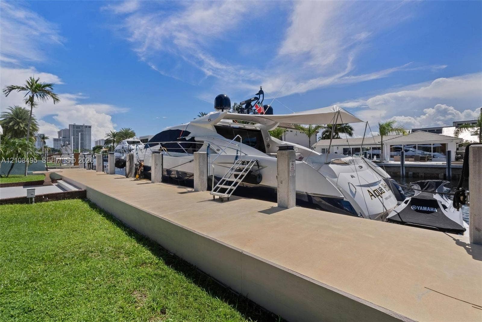 3080 NE 43rd Street, Fort Lauderdale, FL 33308 Concrete dock featuring built-in pilings, manicured turf bordering the water, and direct access to a deep-water canal