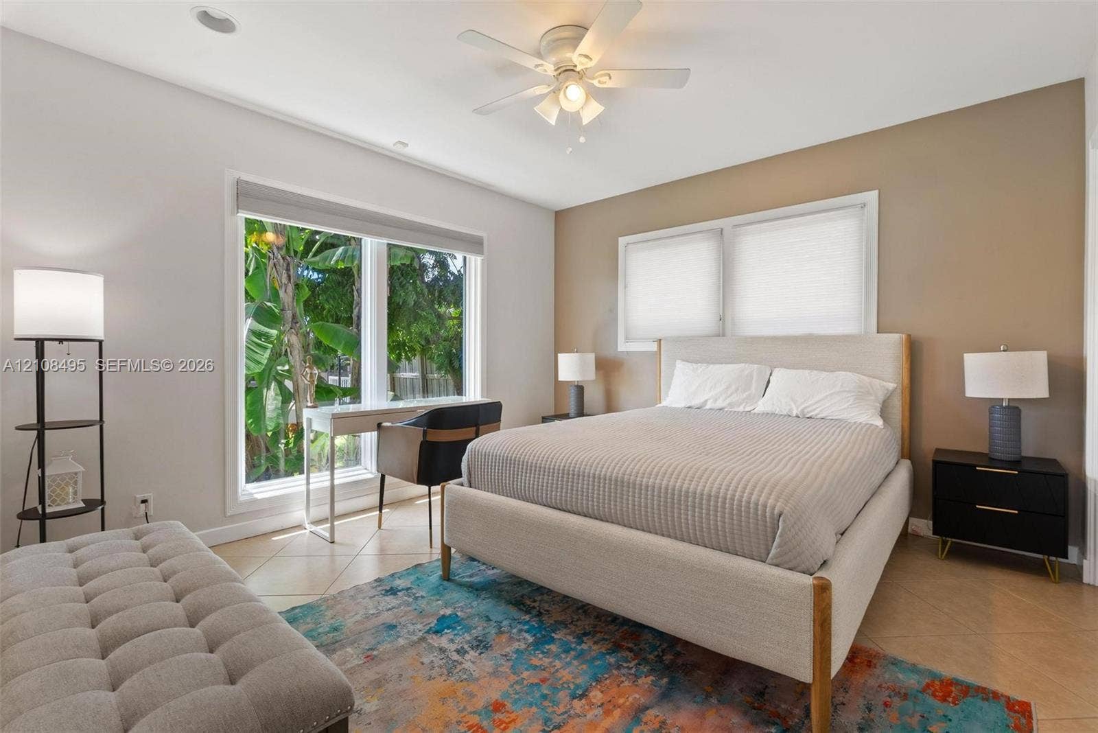 3080 NE 43rd Street, Fort Lauderdale, FL 33308 Spacious room featuring neutral wall tones, large windows, tile flooring, and a ceiling fan with integrated lighting
