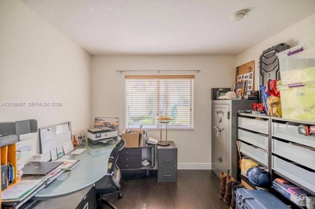 6245 SW 47th Manor, #101, Davie, FL 33314 Room featuring wood-finish flooring, neutral wall paint, and a window with horizontal blinds