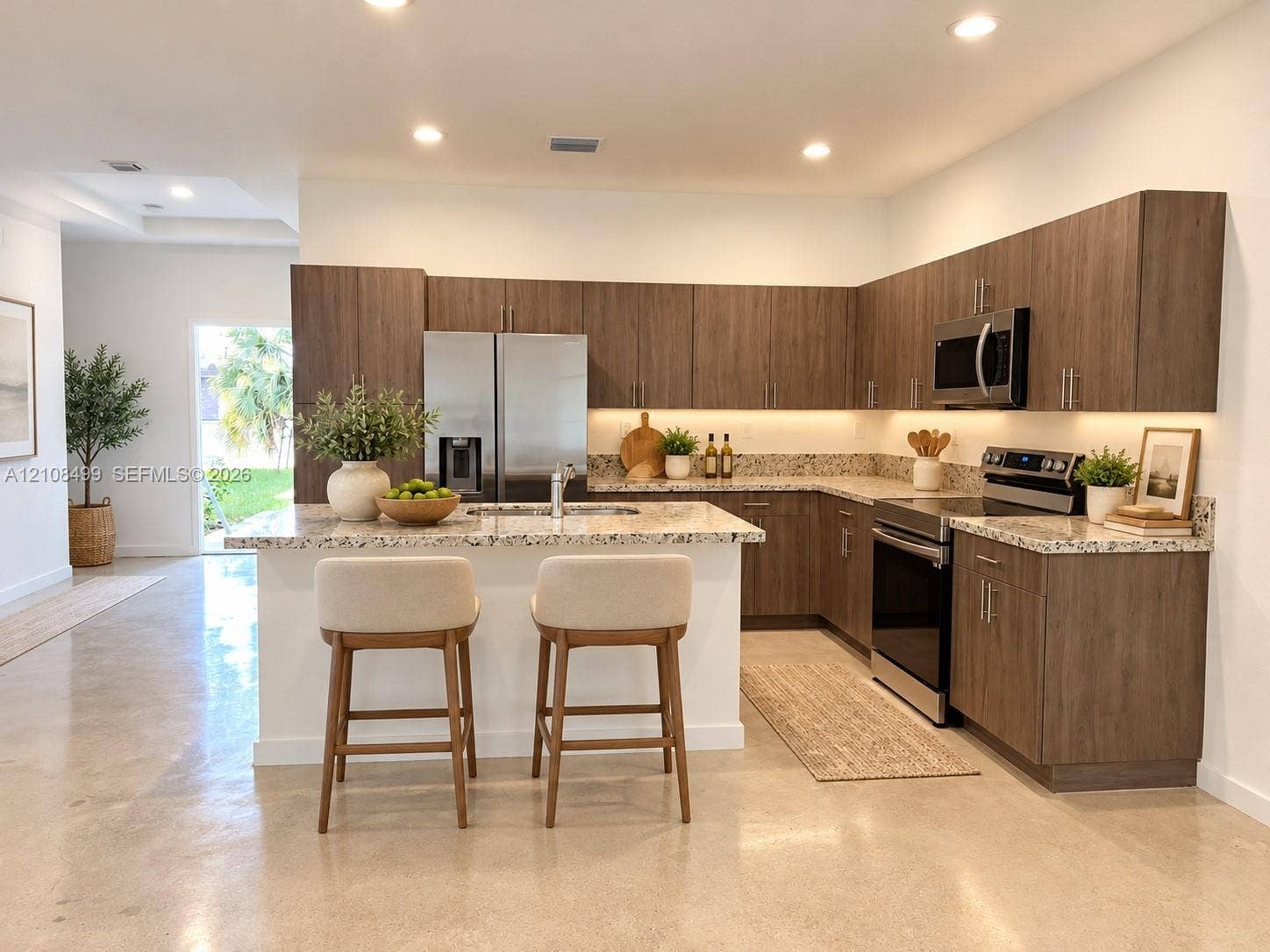 104 NW 31st Avenue, Fort Lauderdale, FL 33311 Kitchen featuring wood-finish cabinetry, stone-surface countertops, stainless steel appliances, under-cabinet lighting, and polished concrete flooring