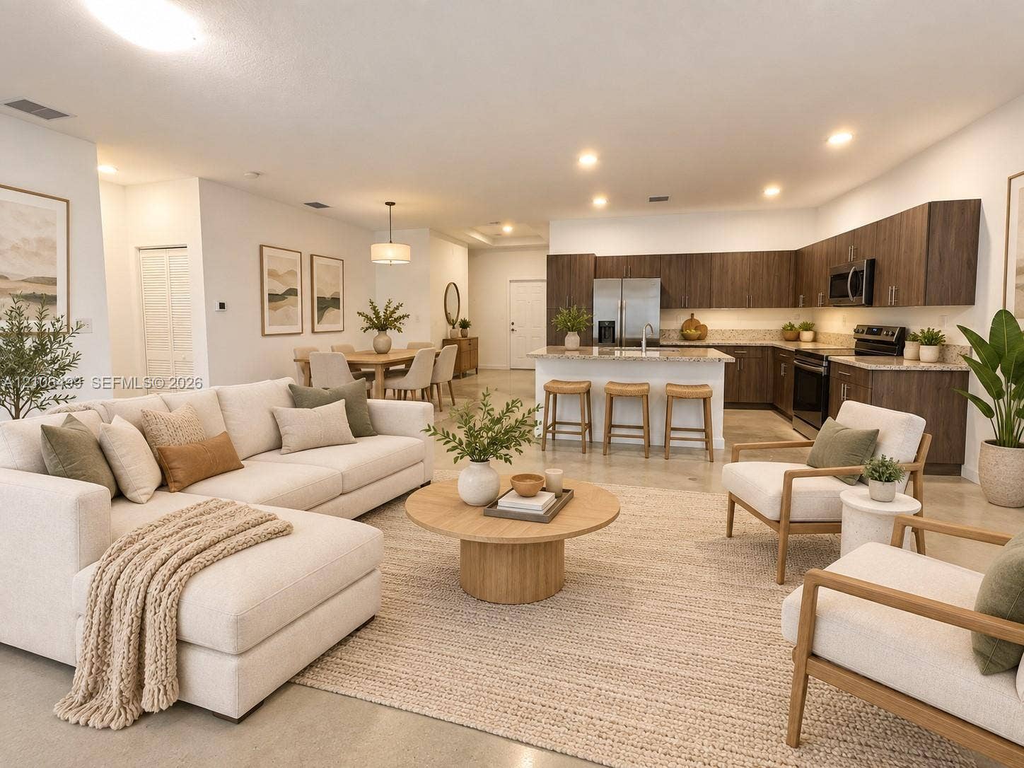 104 NW 31st Avenue, Fort Lauderdale, FL 33311 Open-concept kitchen featuring dark wood-finish cabinetry, stone countertops, and a central island with bar seating, complemented by recessed lighting and polished concrete flooring