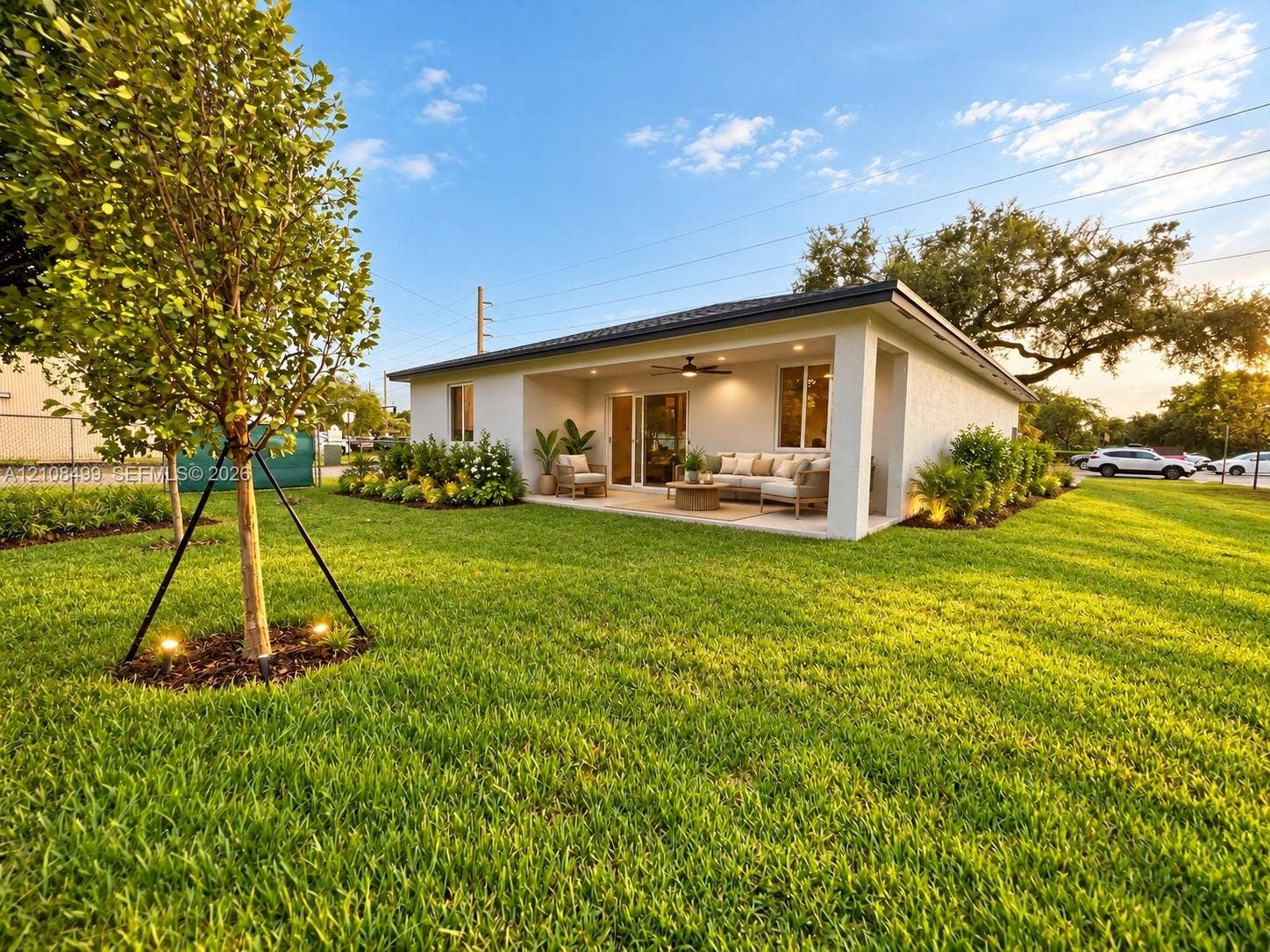 104 NW 31st Avenue, Fort Lauderdale, FL 33311 Stucco exterior featuring a covered patio, recessed ceiling lighting, a mounted ceiling fan, and landscaped grounds