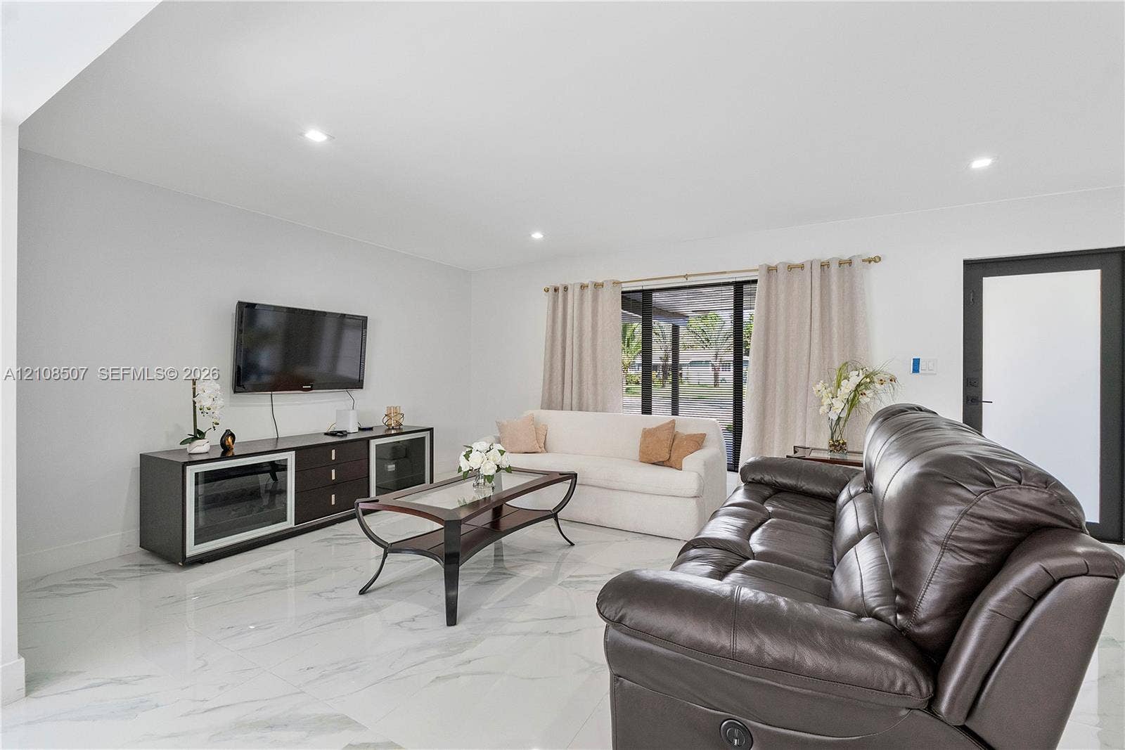451 SW 38th Terrace, #1, Fort Lauderdale, Fort Lauderdale, FL 33312 Polished stone-look flooring, recessed lighting, and expansive glass sliding doors