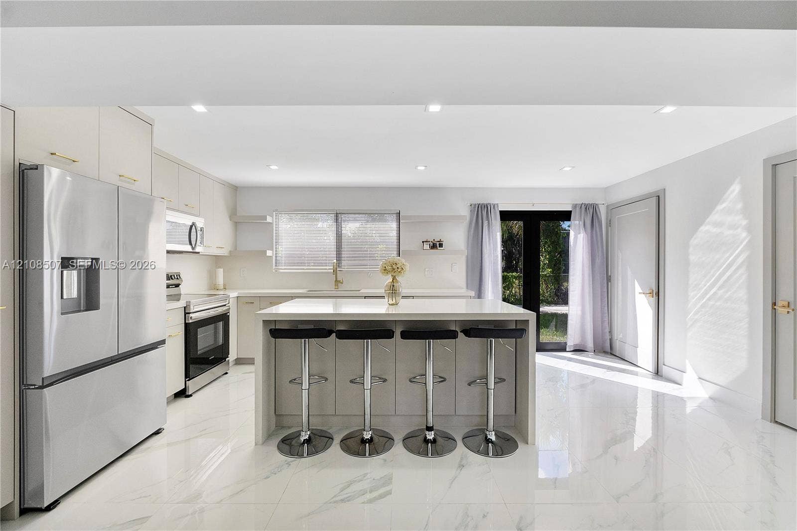 451 SW 38th Terrace, #1, Fort Lauderdale, Fort Lauderdale, FL 33312 Kitchen featuring white cabinetry, a center island with a stone-finish countertop, stainless steel appliances, recessed lighting, and large-format tile flooring