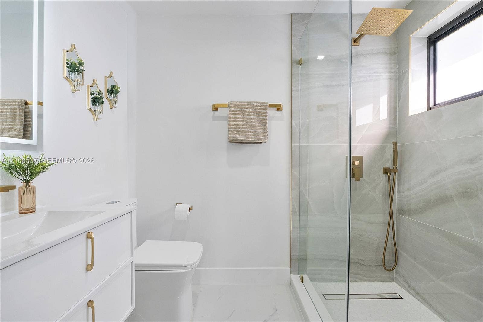 451 SW 38th Terrace, #1, Fort Lauderdale, Fort Lauderdale, FL 33312 Floating vanity with integrated sink, brass hardware, walk-in shower with glass enclosure, wall-mounted rainfall showerhead, and tile-surround shower walls