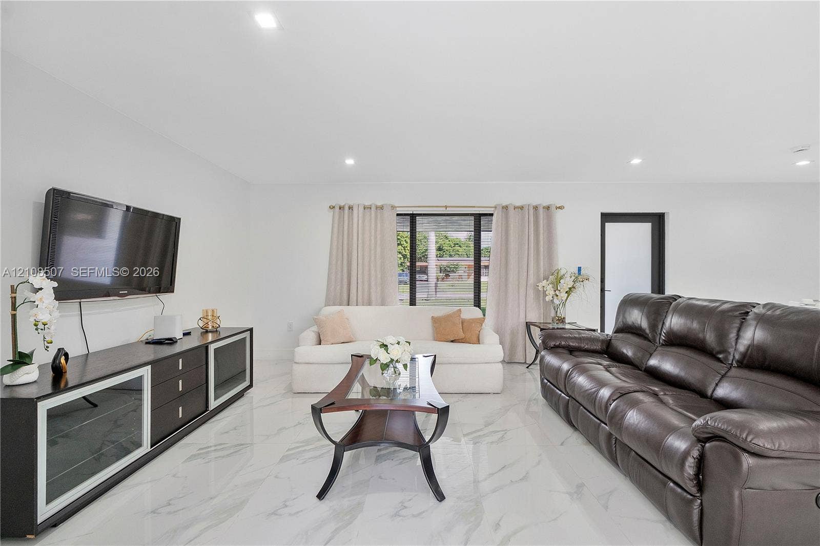 451 SW 38th Terrace, #1, Fort Lauderdale, Fort Lauderdale, FL 33312 Living area featuring large-format tile flooring with a neutral veined pattern and recessed ceiling lighting