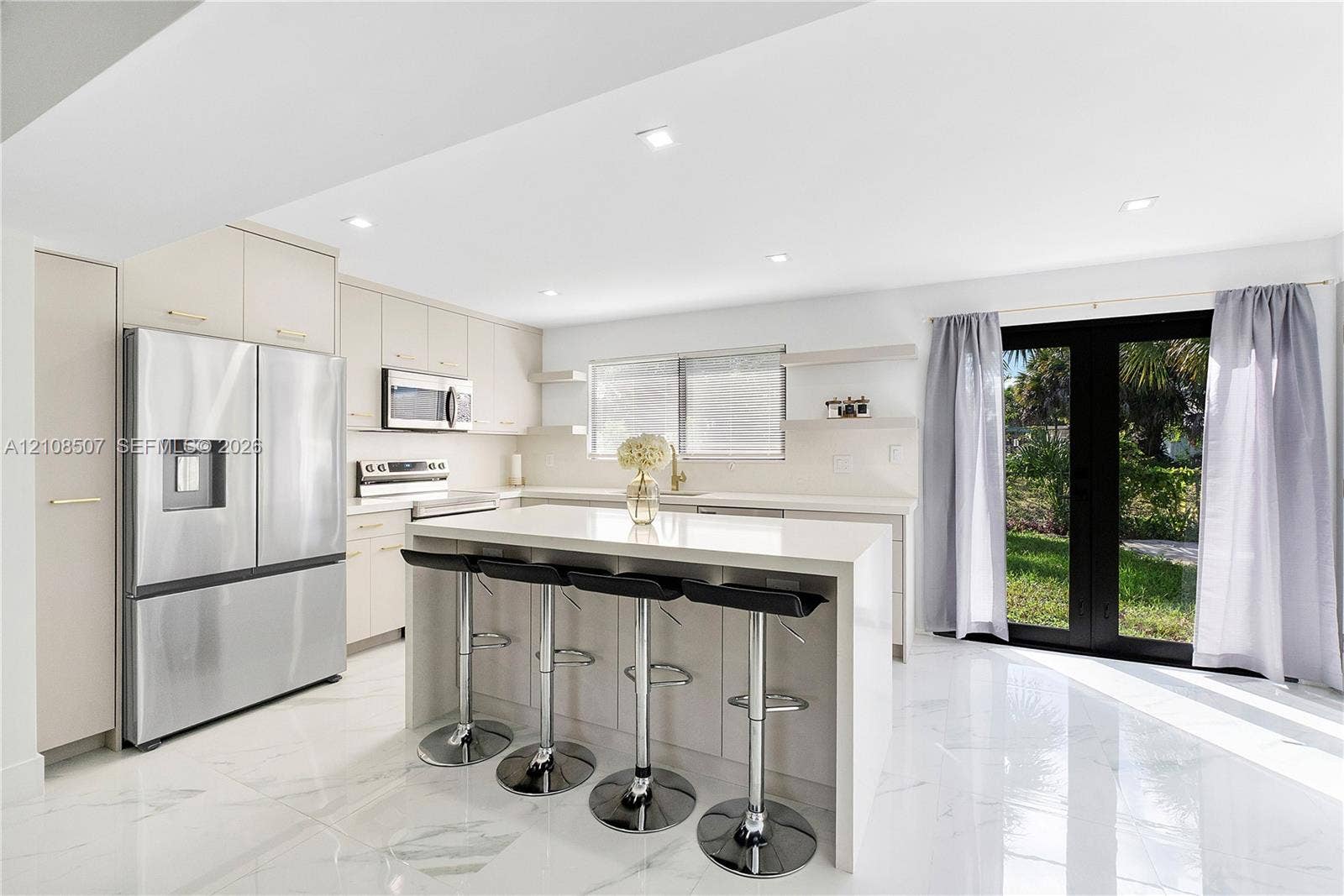 451 SW 38th Terrace, #1, Fort Lauderdale, Fort Lauderdale, FL 33312 Kitchen featuring a center island with quartz countertop, stainless steel appliances, flat-panel cabinetry, recessed lighting, and large glass-panel doors