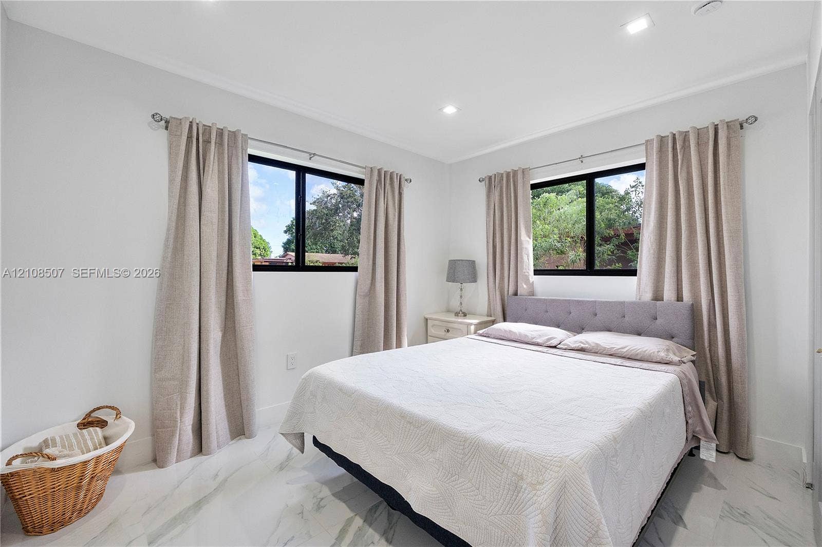 451 SW 38th Terrace, #1, Fort Lauderdale, Fort Lauderdale, FL 33312 Neutral-toned room featuring large windows with black frames, recessed lighting, and white stone-finish tile flooring