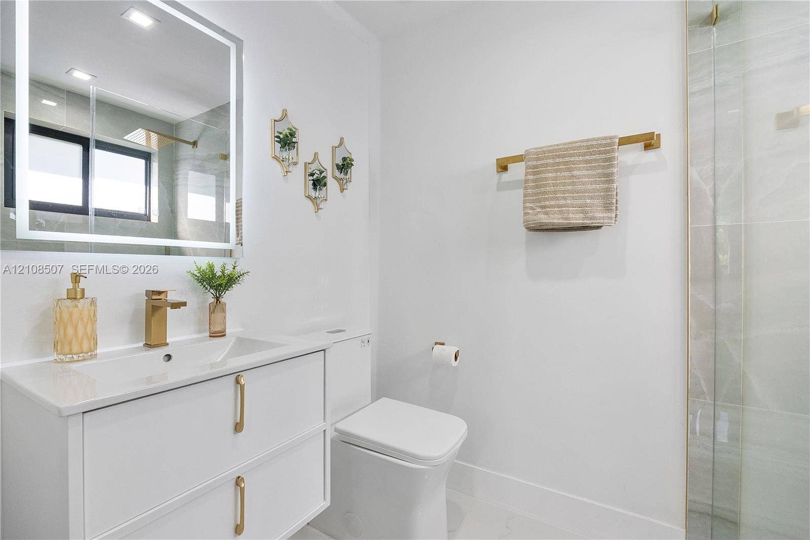 451 SW 38th Terrace, #1, Fort Lauderdale, Fort Lauderdale, FL 33312 Modern floating vanity with a smooth countertop, integrated rectangular sink, and gold-finish hardware