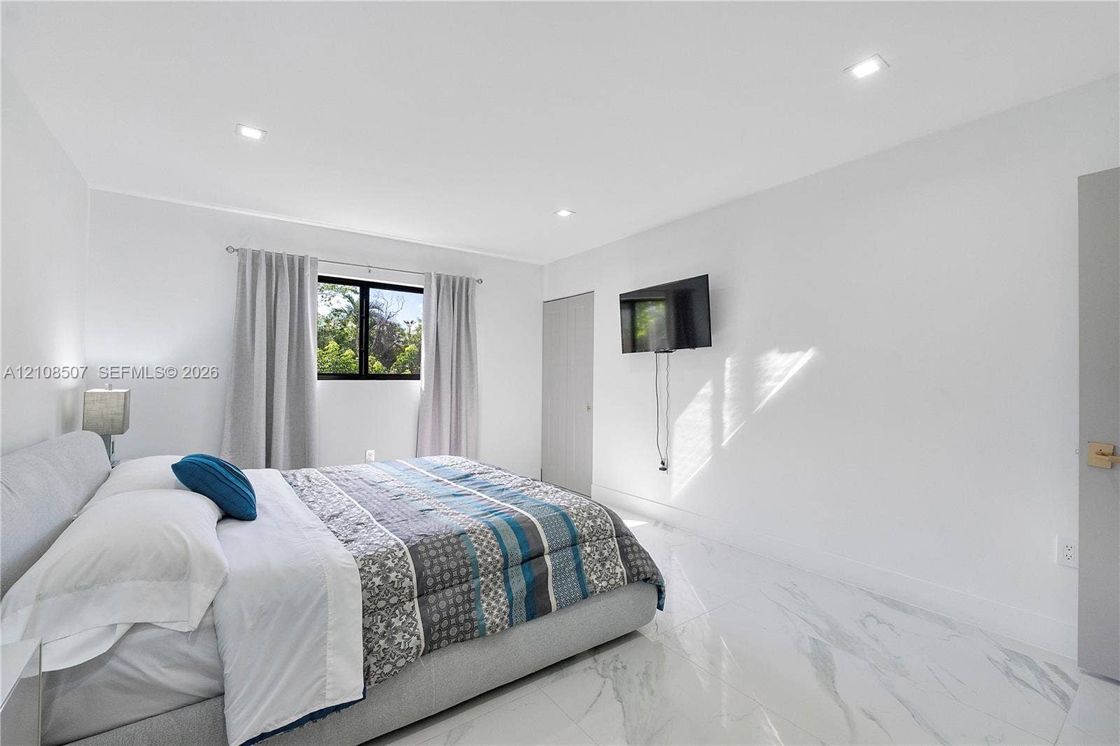 451 SW 38th Terrace, #1, Fort Lauderdale, Fort Lauderdale, FL 33312 Bright room featuring polished white stone-finish flooring, recessed LED lighting, and a window with black frames