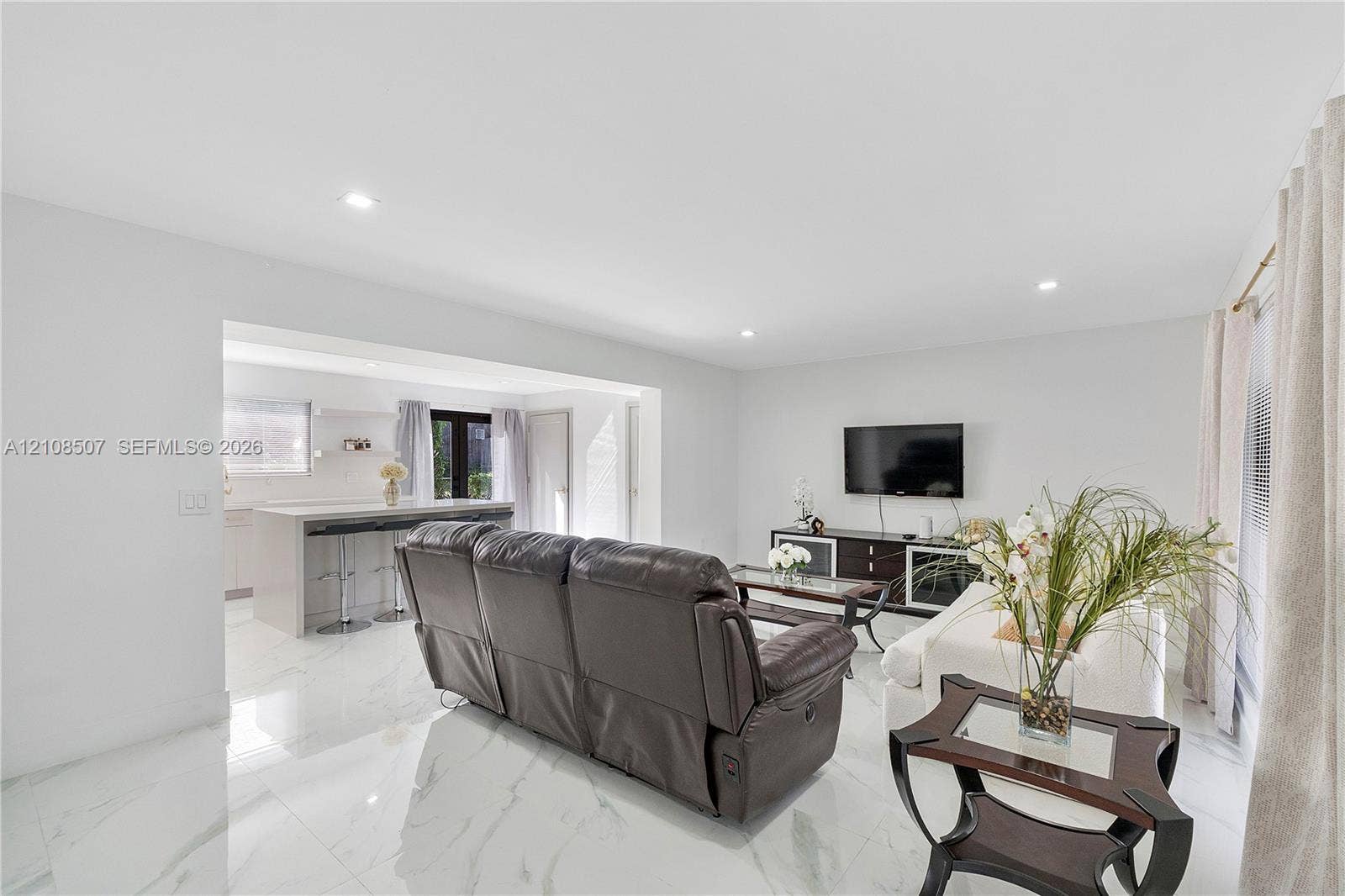 451 SW 38th Terrace, #1, Fort Lauderdale, Fort Lauderdale, FL 33312 Large-format tile flooring, recessed ceiling lighting, and built-in kitchen peninsula with a stone-finish countertop