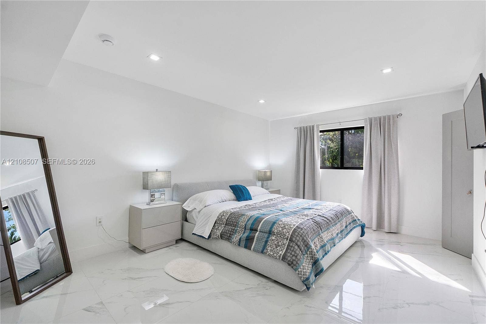 451 SW 38th Terrace, #1, Fort Lauderdale, Fort Lauderdale, FL 33312 Large-format polished stone flooring, recessed ceiling lighting, and a single window with dark-toned framing