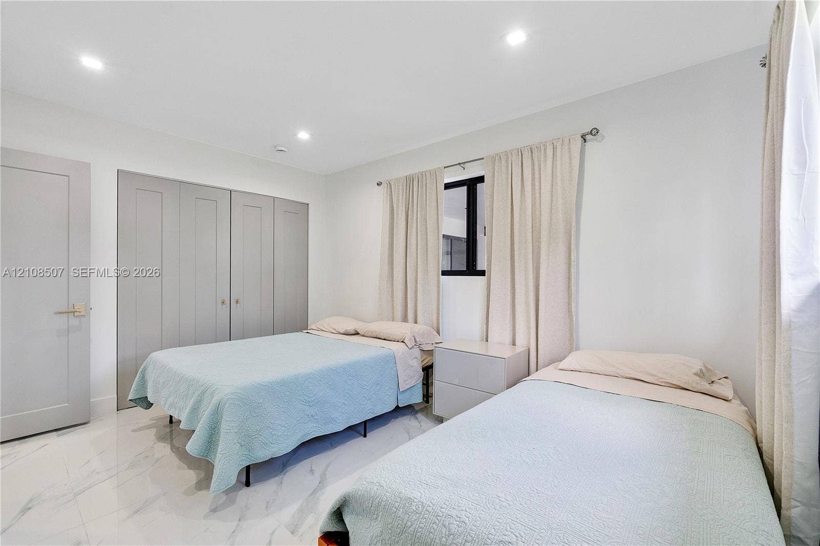 451 SW 38th Terrace, #1, Fort Lauderdale, Fort Lauderdale, FL 33312 Bedroom featuring large-format light-toned tile flooring, recessed ceiling lighting, and built-in shaker-style closet cabinetry with neutral hardware