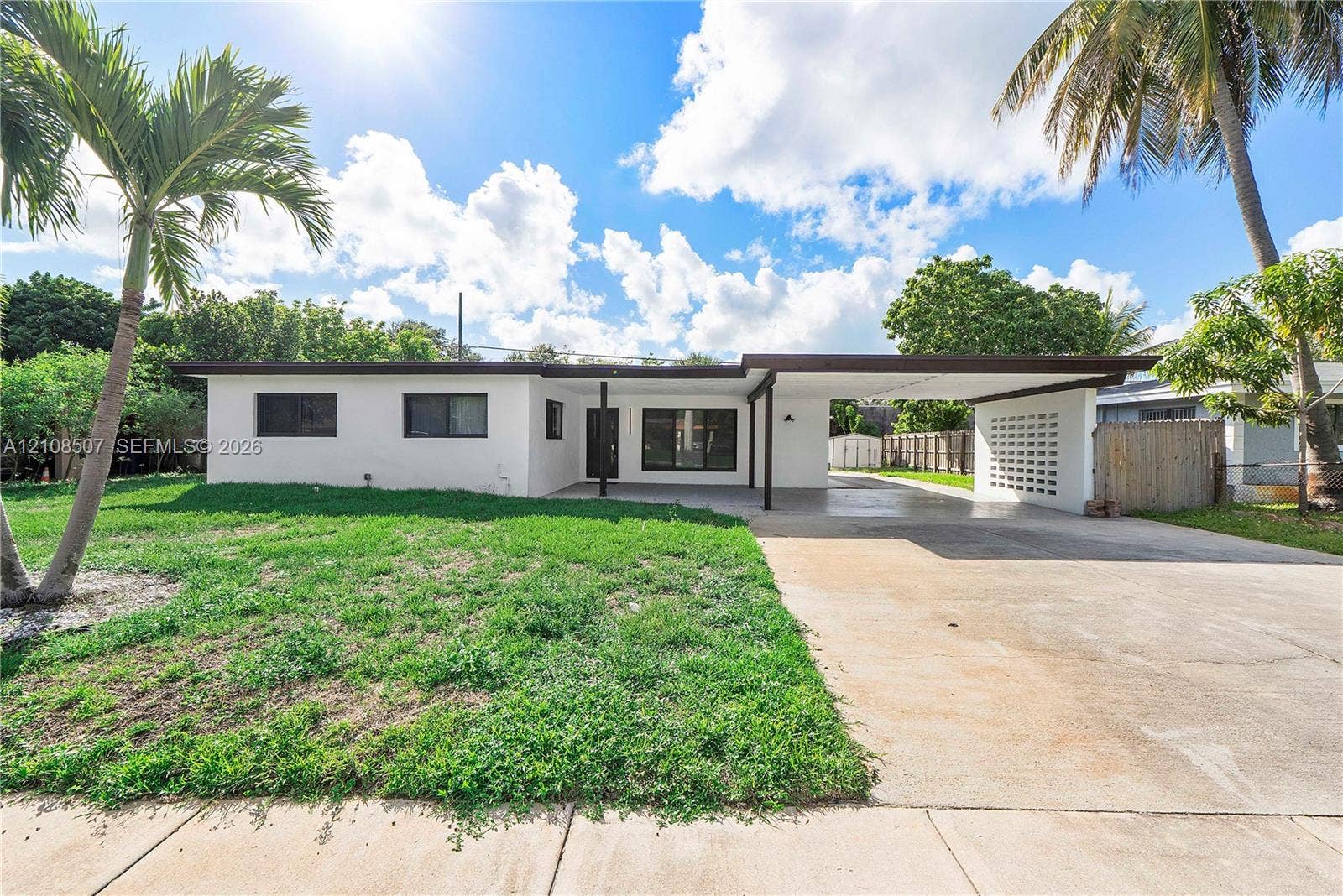 451 SW 38th Terrace, #1, Fort Lauderdale, Fort Lauderdale, FL 33312 Single-story residence featuring a flat roofline, attached covered carport, decorative masonry screen wall, and concrete driveway