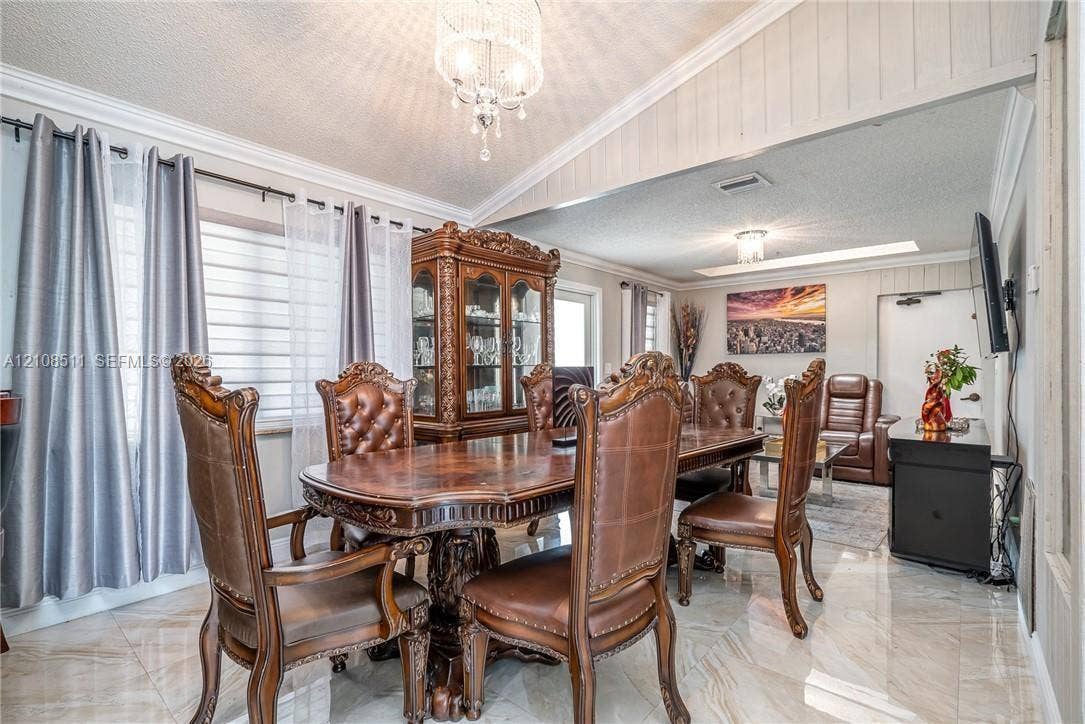 Miramar, Miramar, FL 33025 Polished stone flooring, vaulted ceilings, and decorative crystal chandelier