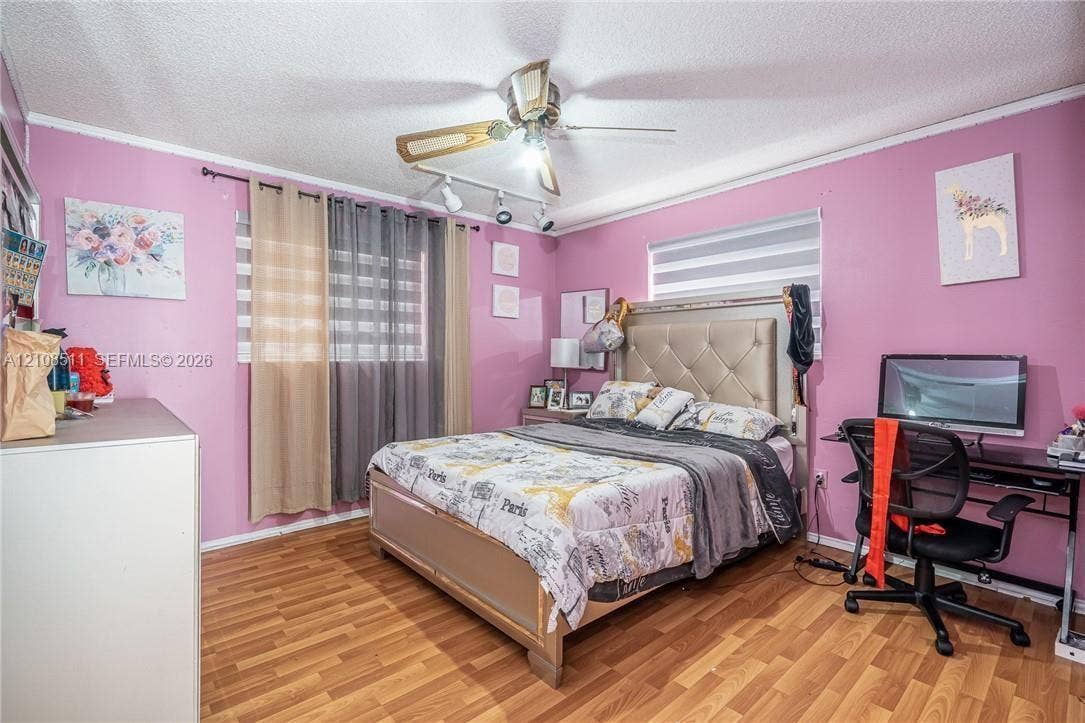 Miramar, Miramar, FL 33025 Wood-finish flooring, dual-track light fixture, and ceiling fan with integrated lighting