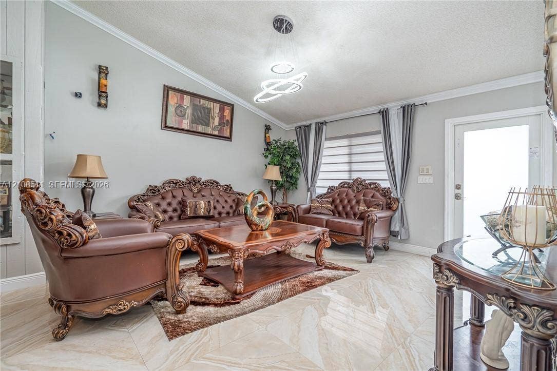 Miramar, Miramar, FL 33025 Living area featuring polished tile flooring, contemporary multi-ring LED light fixture, and crown molding