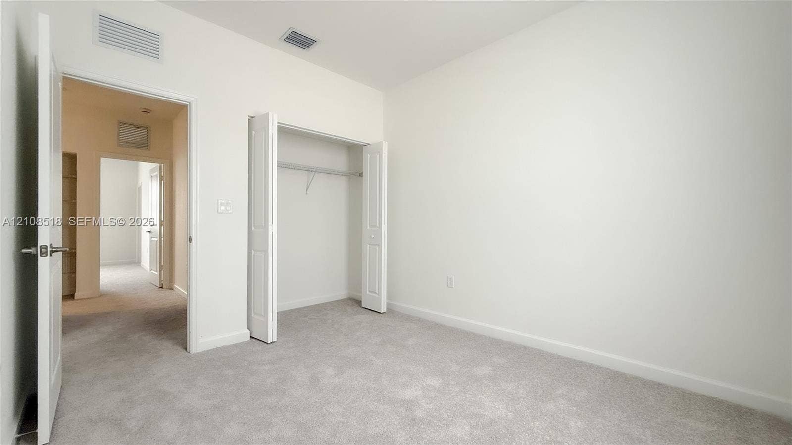27733 SW 155th Court, #27733, Homestead, Homestead, FL 33032 Neutral-toned wall paint, wall-to-wall carpeting, and a bi-fold door closet