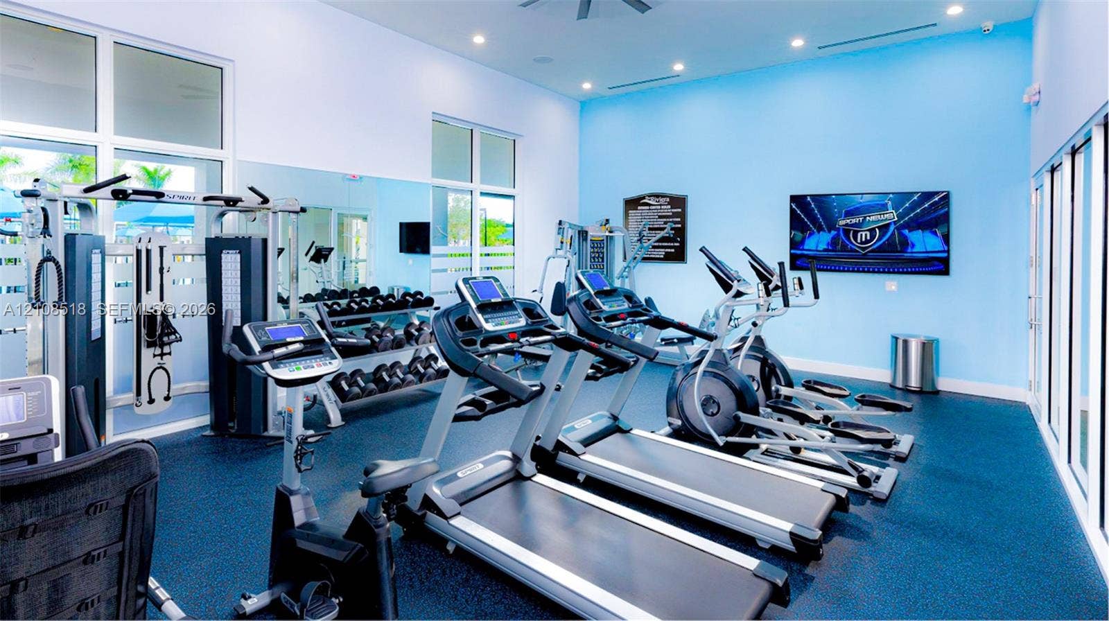 27733 SW 155th Court, #27733, Homestead, Homestead, FL 33032 Fitness center featuring rubber flooring, floor-to-ceiling mirrored walls, recessed lighting, and expansive glass panels