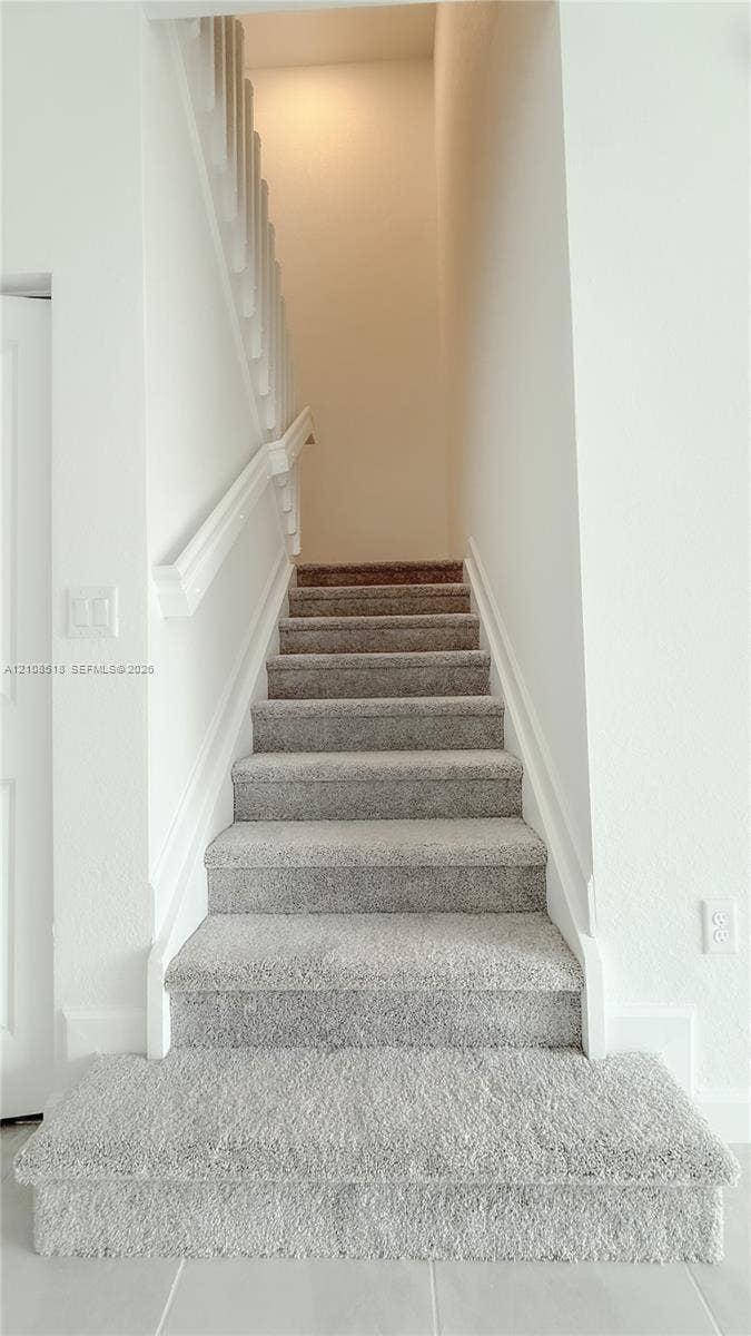 27733 SW 155th Court, #27733, Homestead, Homestead, FL 33032 Staircase featuring neutral-tone carpeting, white painted wooden handrails, and white millwork
