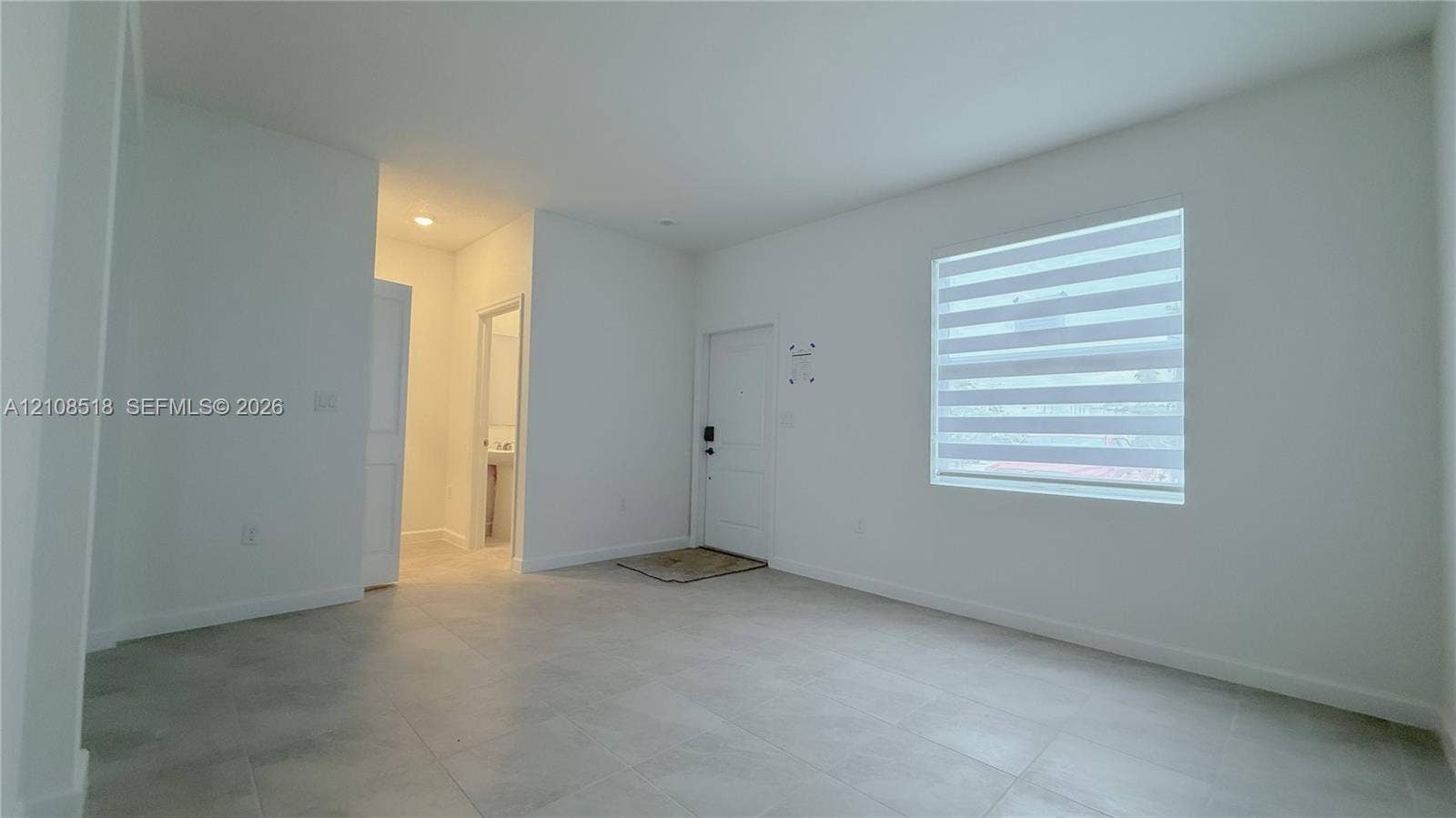 27733 SW 155th Court, #27733, Homestead, Homestead, FL 33032 Interior space featuring neutral wall paint, large-format tile flooring, recessed ceiling lighting, and a single-panel entry door