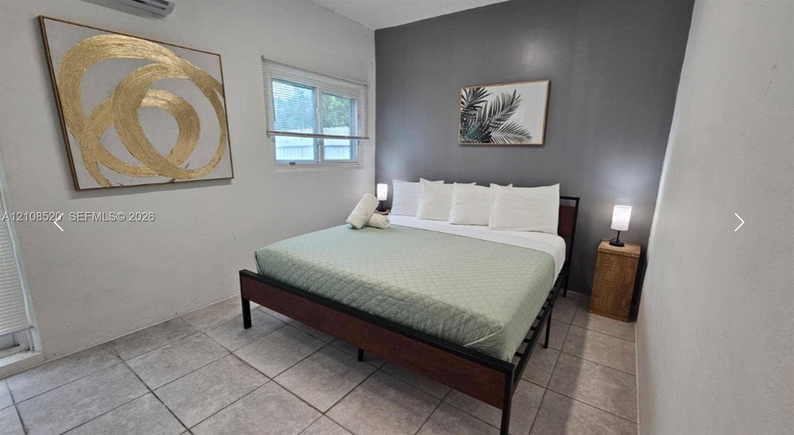 4536 SW 24th Avenue, Dania, Dania Beach, FL 33312 Room featuring tile flooring, a charcoal accent wall, and a wall-mounted climate control unit