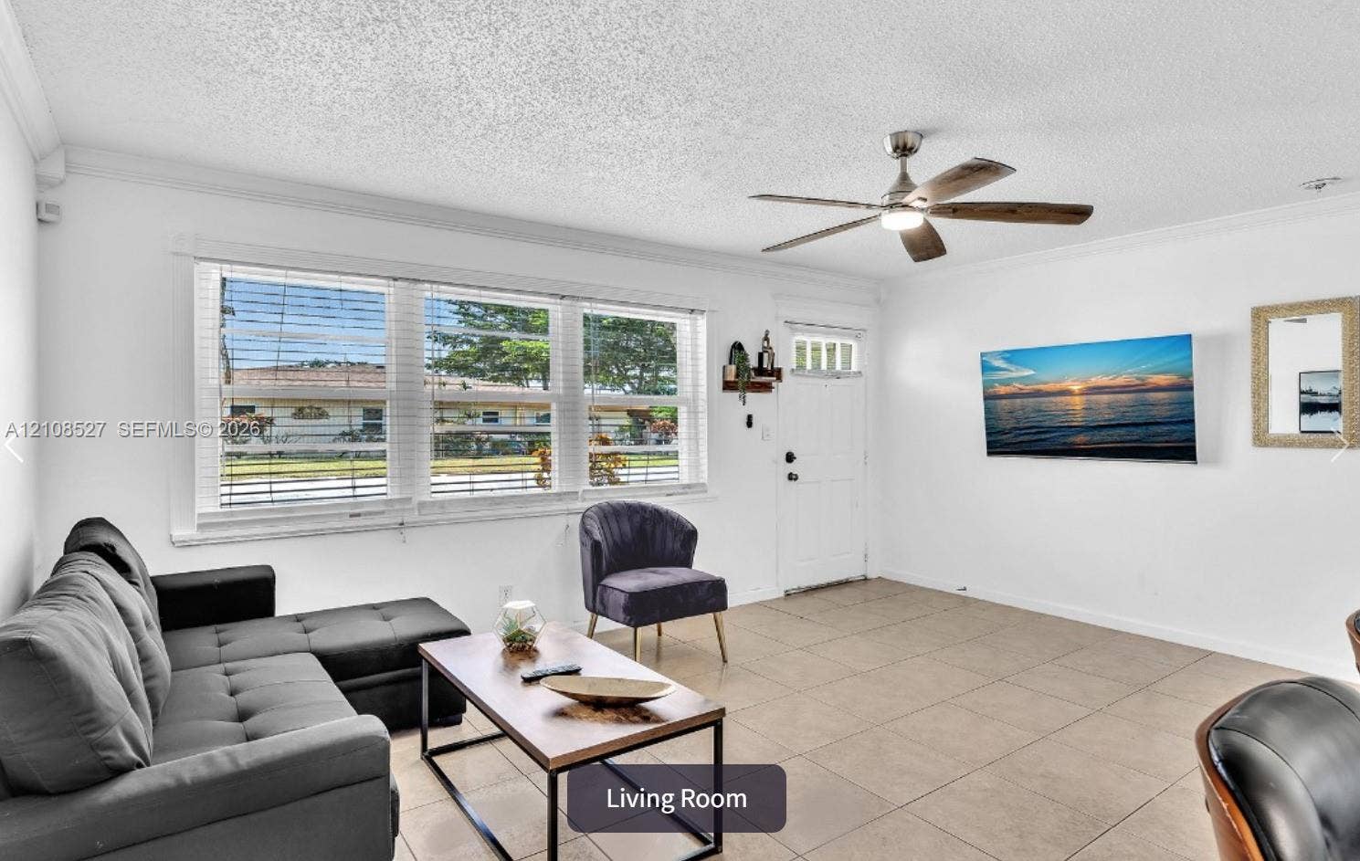 4549 SW 24th Avenue, Dania, Dania Beach, FL 33312 Living room featuring tile flooring, crown molding, large windows, and a ceiling fan with integrated light fixture