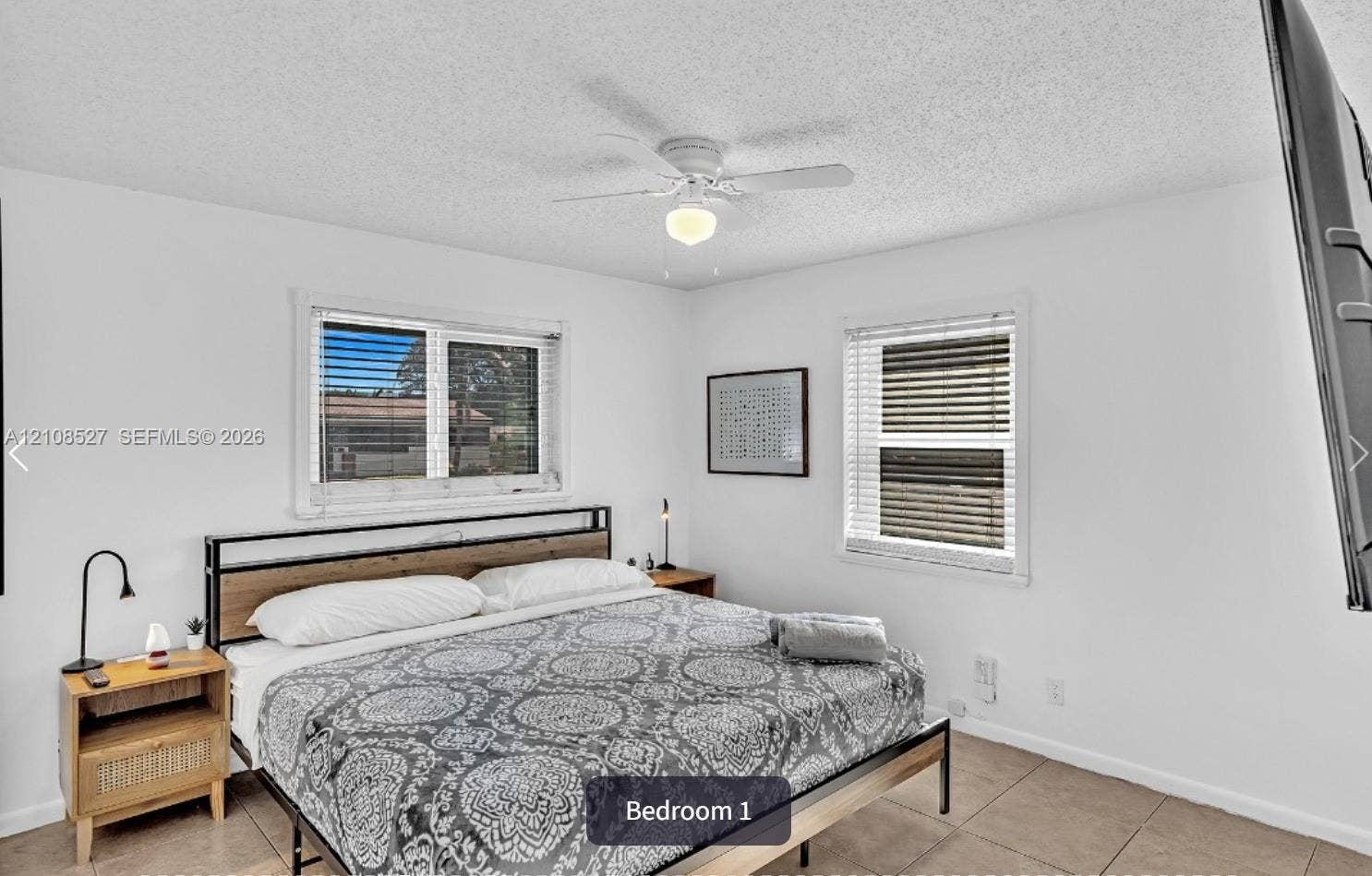 4549 SW 24th Avenue, Dania, Dania Beach, FL 33312 Neutral interior room featuring tile flooring, white walls, dual windows with integrated blinds, and a ceiling fan with light fixture