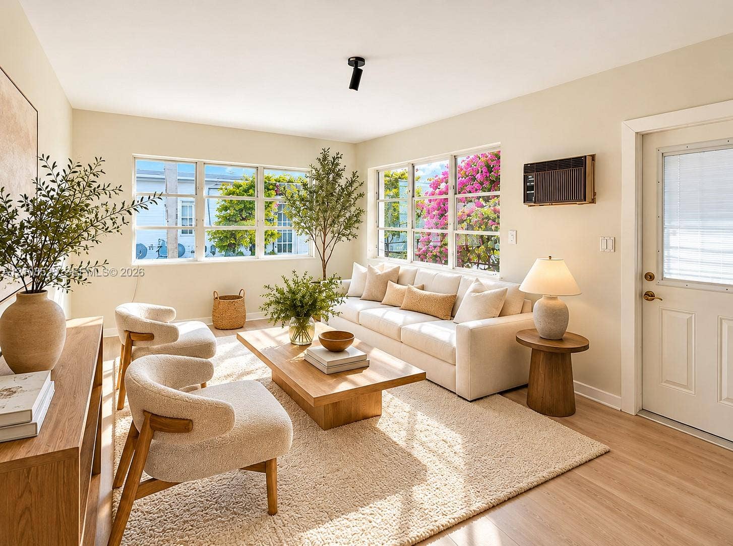 1124 N 18th Avenue N, Lake Worth, FL 33460 Living area featuring large paneled windows, wood-finish flooring, and a single black ceiling-mounted spotlight