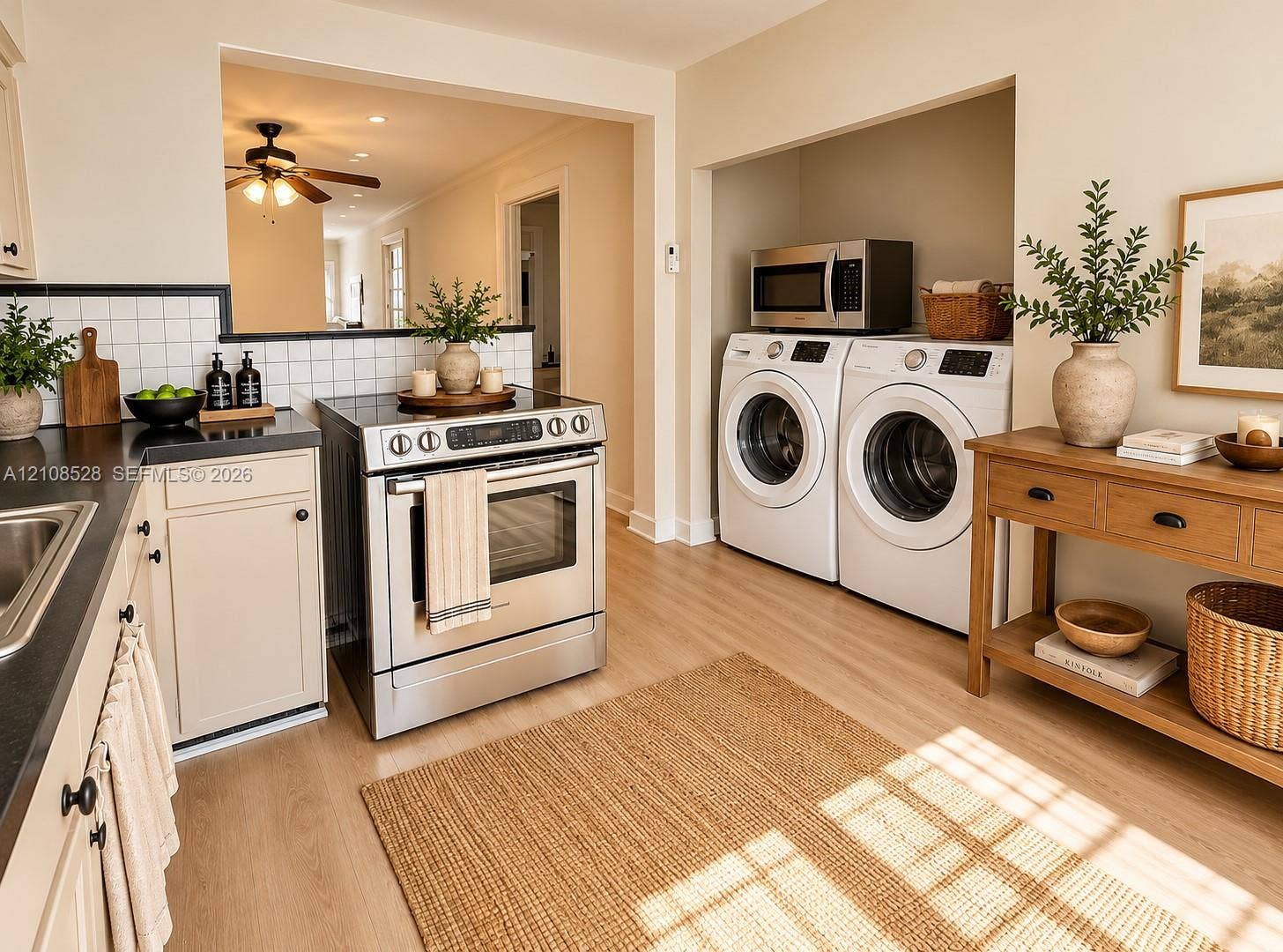1124 N 18th Avenue N, Lake Worth, FL 33460 Kitchen featuring stainless steel slide-in range, wood-finish flooring, white square-tile backsplash, and integrated laundry alcove