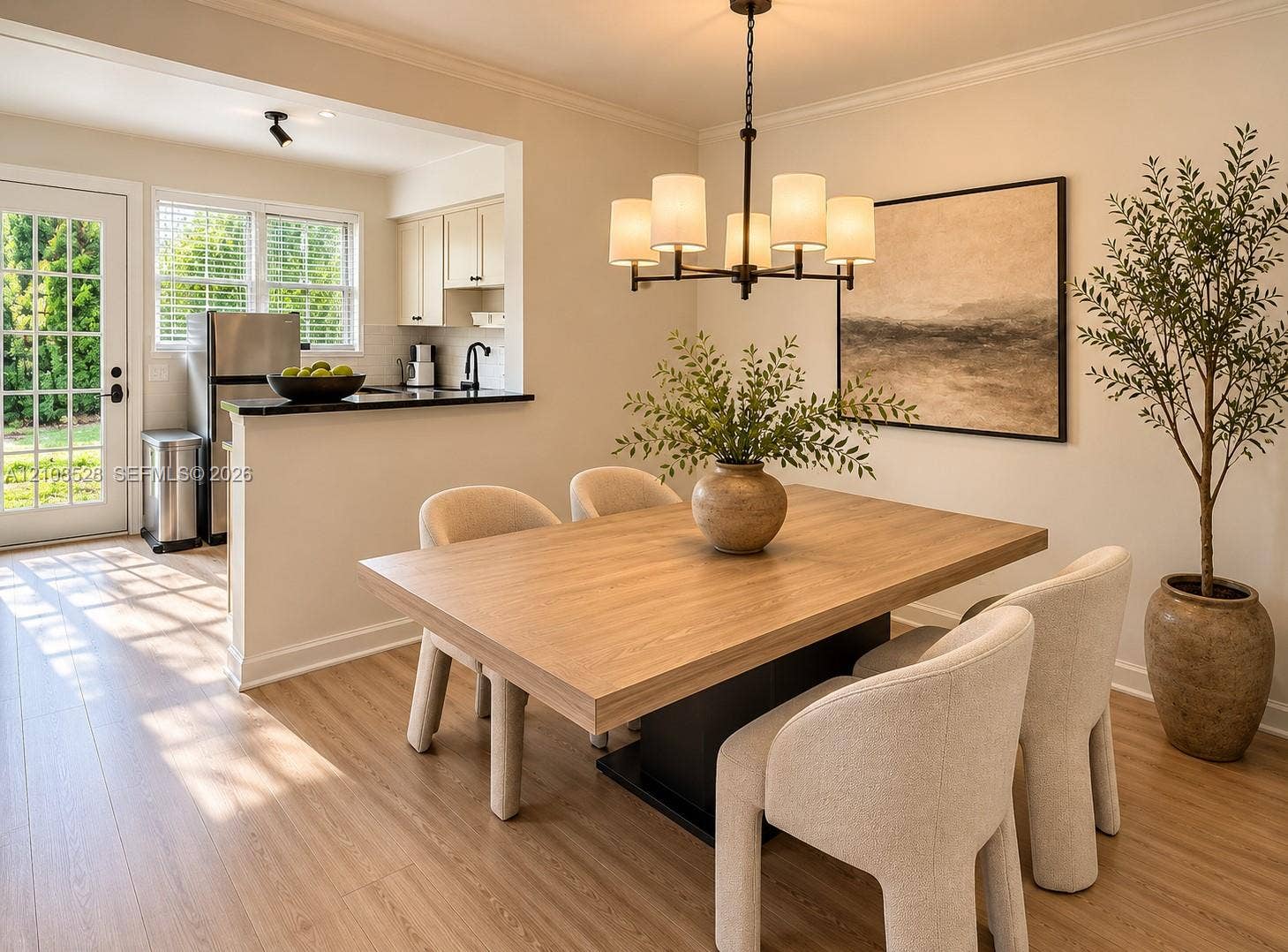 1124 N 18th Avenue N, Lake Worth, FL 33460 Dining area featuring wood-finish flooring, a contemporary five-light chandelier, and a breakfast bar with stone-finish countertops
