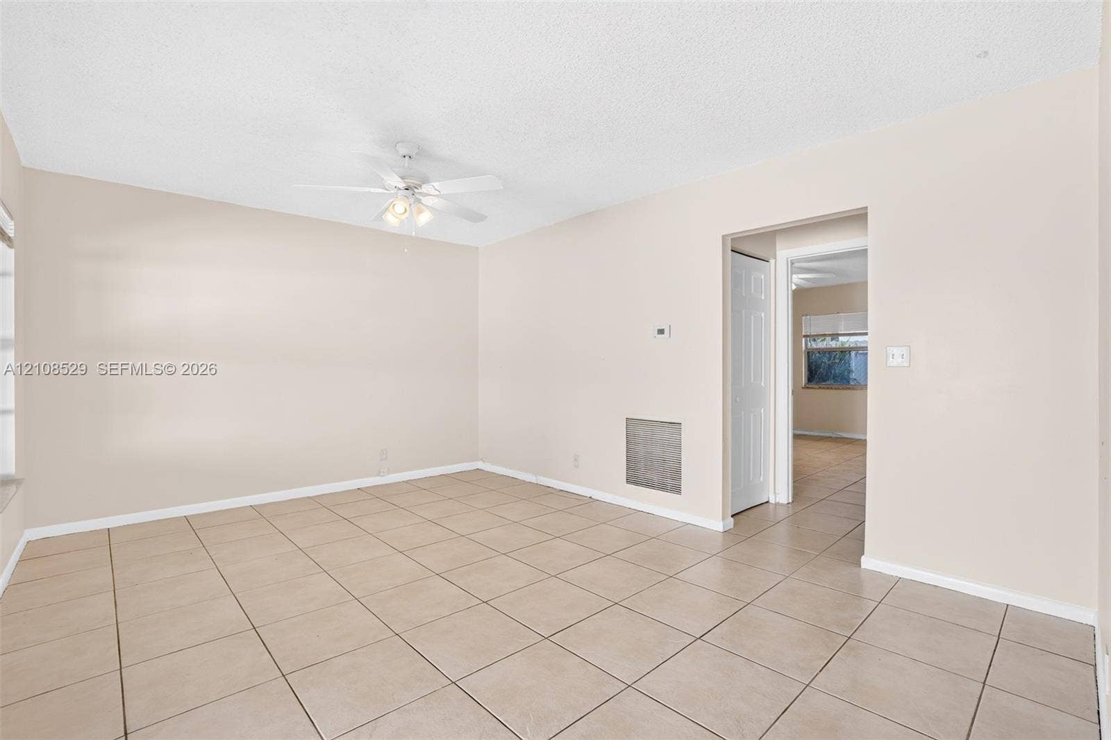 1015 SW 4th Avenue, #A, Fort Lauderdale, Fort Lauderdale, FL 33315 Neutral-toned interior featuring ceramic tile flooring, a white ceiling fan with integrated lighting, and a textured ceiling finish