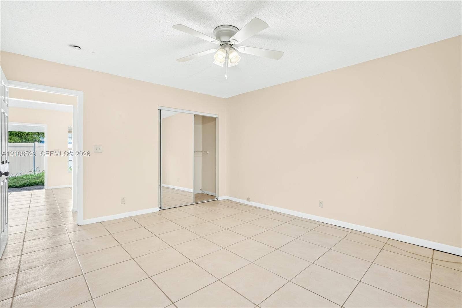1015 SW 4th Avenue, #A, Fort Lauderdale, Fort Lauderdale, FL 33315 Neutral interior space featuring tile flooring, a ceiling fan with integrated lighting, and a closet with mirrored sliding doors