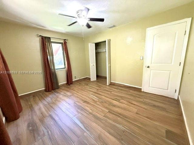 1124 NE 7th Street, Hallandale Beach, Hallandale Beach, FL 33009 Wood-finish flooring, ceiling fan with integrated lighting, closet with bifold doors, and panel-style interior door