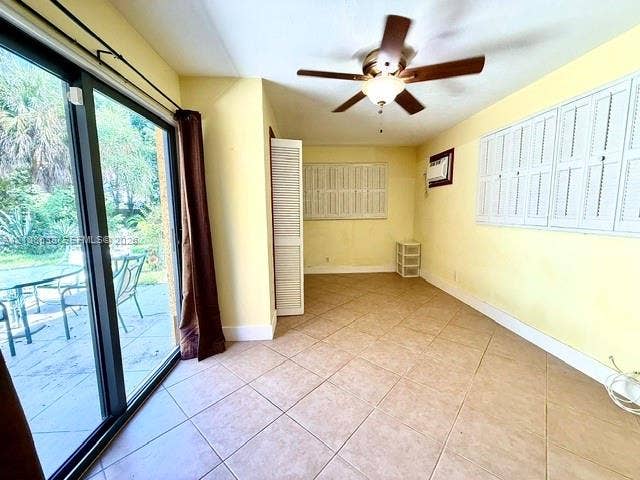 1124 NE 7th Street, Hallandale Beach, Hallandale Beach, FL 33009 Sunroom featuring tile flooring, sliding glass doors, white louvered shutters, and a ceiling fan