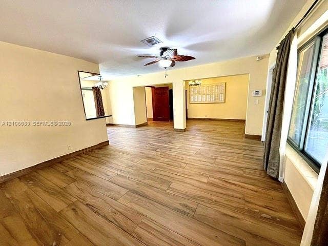 1124 NE 7th Street, Hallandale Beach, Hallandale Beach, FL 33009 Open-concept interior featuring wood-finish flooring, a ceiling fan, sliding glass doors, and recessed pass-through window