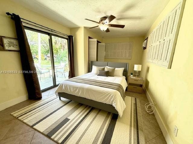 1124 NE 7th Street, Hallandale Beach, Hallandale Beach, FL 33009 Sliding glass door, tiled flooring, ceiling fan with integrated lighting, and louvered wall shutters