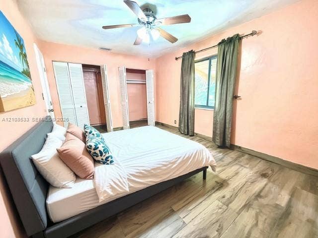 1124 NE 7th Street, Hallandale Beach, Hallandale Beach, FL 33009 Wood-finish flooring, dual bi-fold door closets, and a ceiling fan with integrated lighting