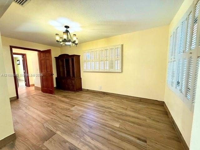 1124 NE 7th Street, Hallandale Beach, Hallandale Beach, FL 33009 Wood-finish flooring throughout, white plantation shutters, and a multi-light chandelier