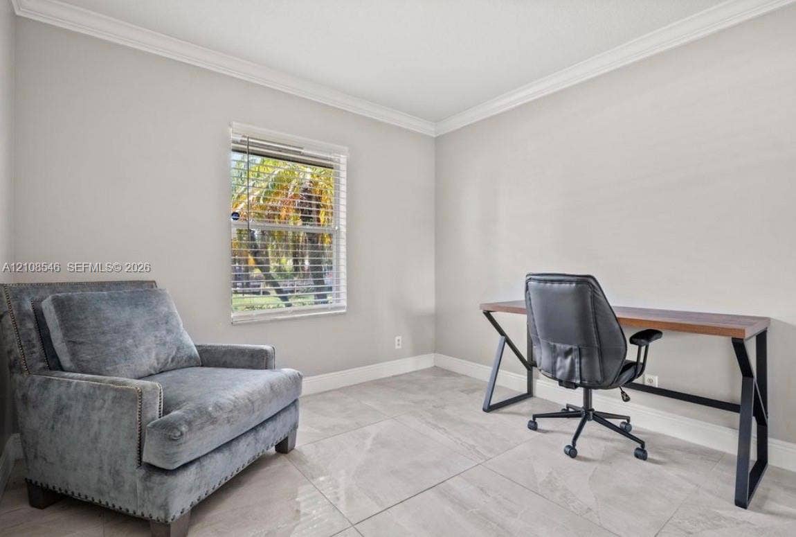 Neutral-toned walls with crown molding, large-format tile flooring, and window featuring horizontal blinds