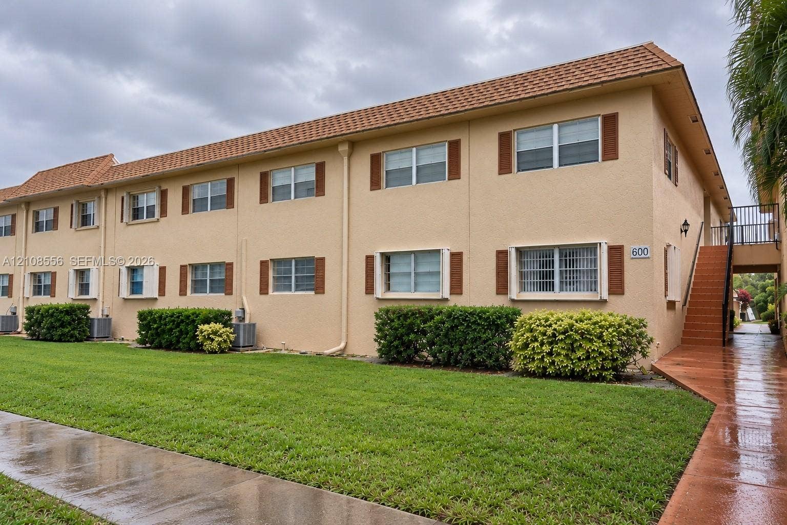 600 SW 2nd Avenue, #137, Boca Raton, FL 33432 Two-story exterior featuring a stucco facade, clay-tile roof, shuttered windows, and external staircase